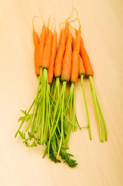 Fresh carrots on the wooden table — Stock Photo, Image