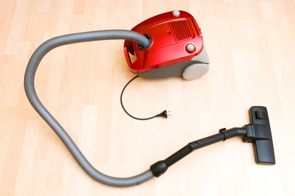 Vacuum cleaner on the wooden floor — Stock Photo, Image