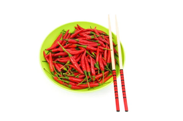 Hot peppers with chopsticks and plate — Stock Photo, Image