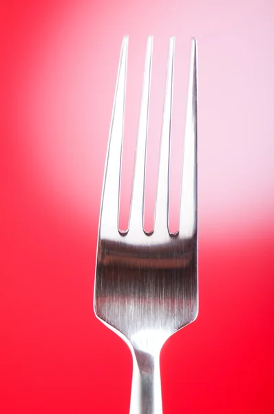Silver fork against gradient color background — Stock Photo, Image