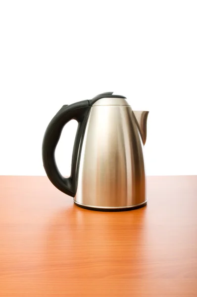 Shiny tea kettle on the wooden table — Stock Photo, Image