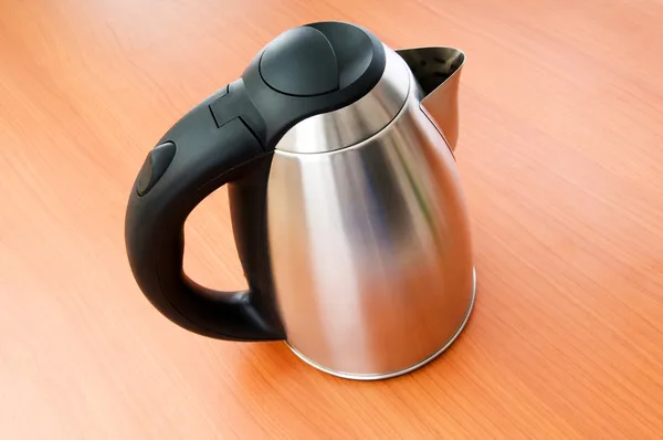 Shiny tea kettle on the wooden table — Stock Photo, Image