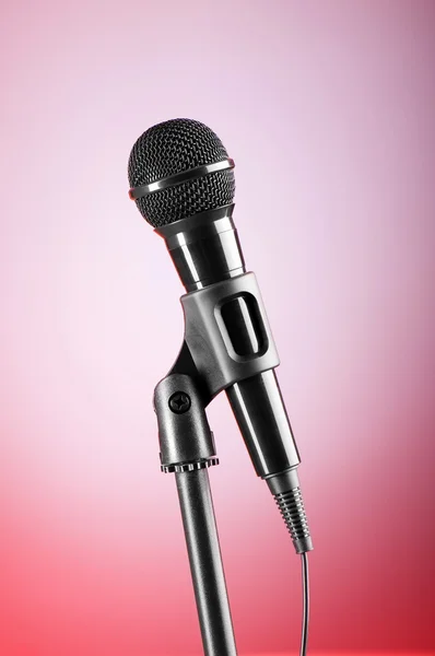 Microfone preto contra o fundo gradiente colorido — Fotografia de Stock