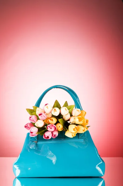 Bag and flowers against the colorful background — Stock Photo, Image