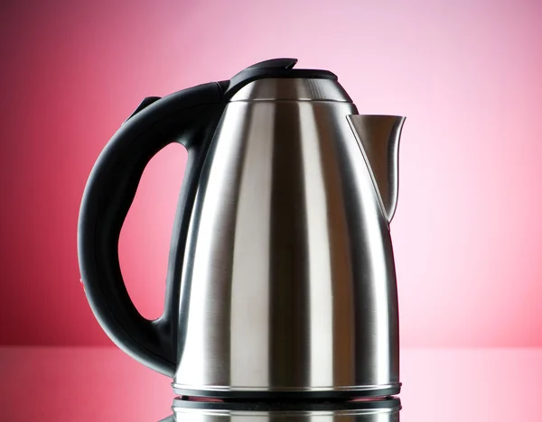 Shiny kettle against the colorful gradient background — Stock Photo, Image