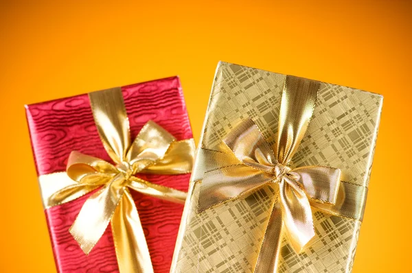 Celebration concept - Gift box against colorful background — Stock Photo, Image