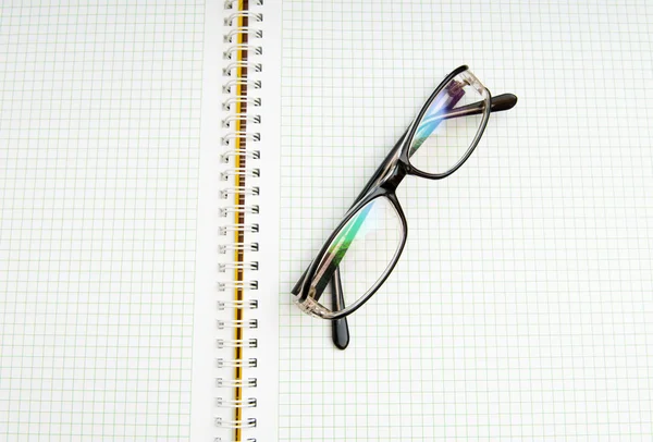 Reading glasses on the black page — Stock Photo, Image