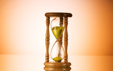 Time concept - hourglass against the gradient background clipart