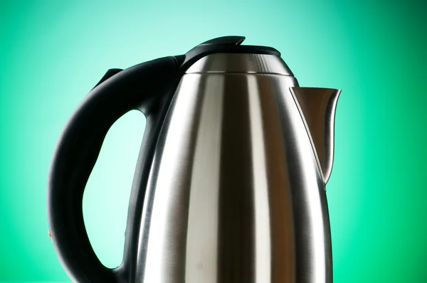 Shiny kettle against the colorful gradient background — Stock Photo, Image