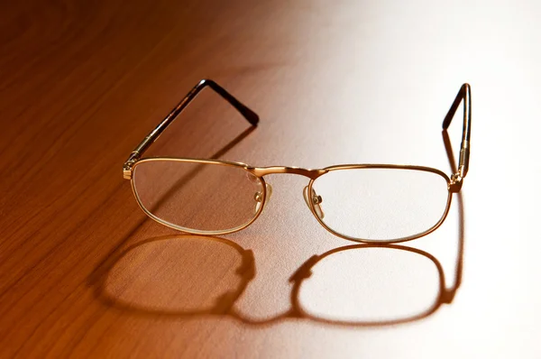 Ahşap zemin üzerinde Okuma gözlükleri — Stok fotoğraf