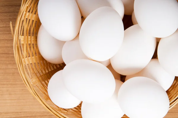 Many white eggs on the wooden table — Stock Photo, Image
