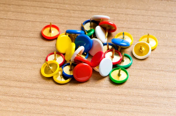 Many colourful office pins on the background — Stock Photo, Image