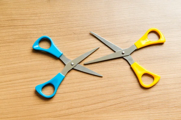 Various scissors on the wooden background — Stock Photo, Image