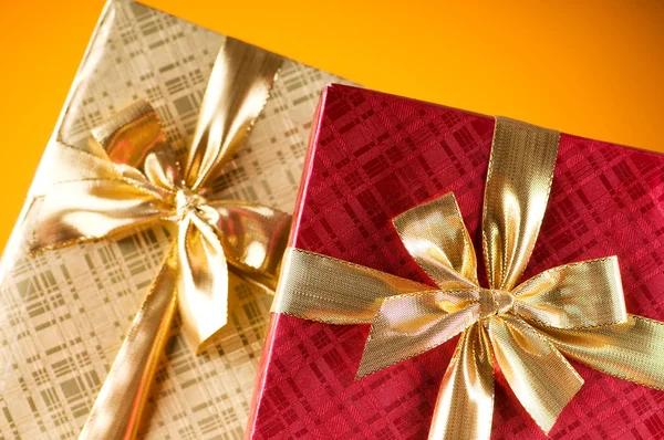 Celebration concept - Gift box against colorful background Royalty Free Stock Photos
