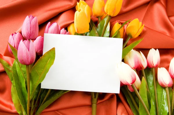 Envelope and flowers on the satin background Stock Picture