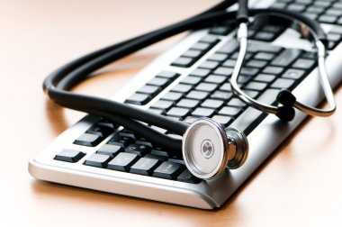 Stethoscope and keyboard illustrating concept of digital securit clipart