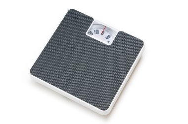 Dieting concept with scales isolated on the white clipart