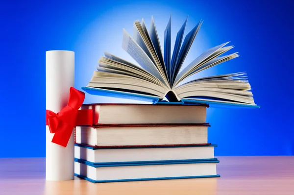 Diploma and stack of books against the background — Stock Photo, Image