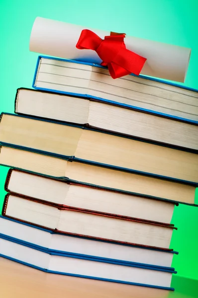Diploma and stack of books against the background — Stock Photo, Image