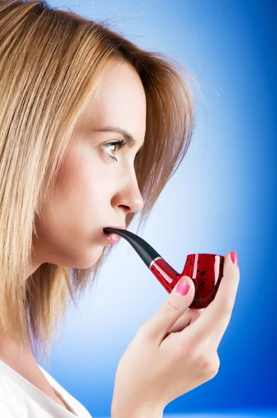 Girl smoking pipe against the gradient background — Stock Photo, Image