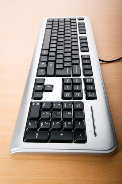 Computer keyboard on the wooden polished table — Stock Photo, Image