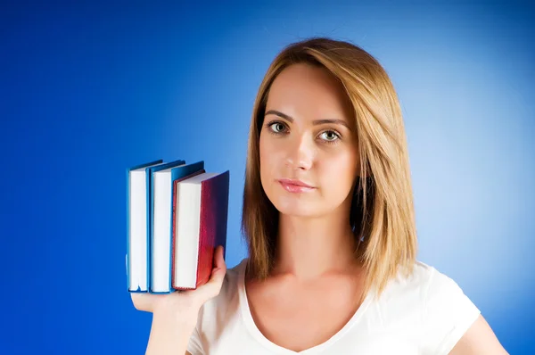 Young university student with many study textbooks Stock Picture