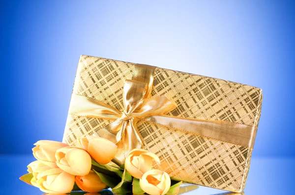 Celebration concept - gift box and tulip flowers Royalty Free Stock Images