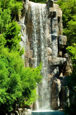 Tall waterfalls on the bright summer day clipart