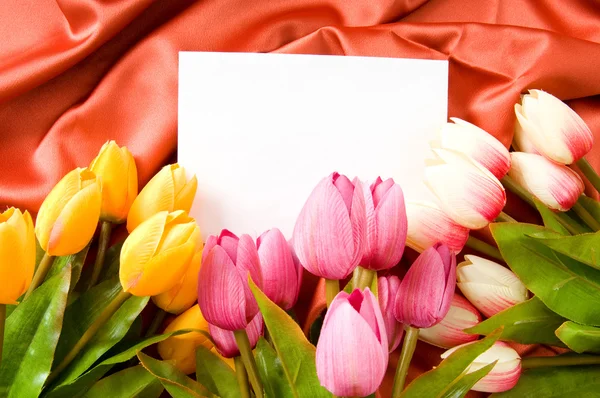 Envelope and flowers on the satin background Stock Photo