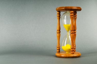 Time concept - hourglass against the gradient background clipart