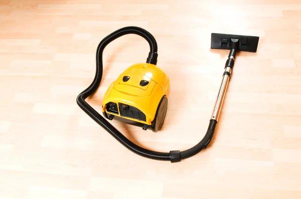 Vacuum cleaner on the polished wooden floor — Stock Photo, Image