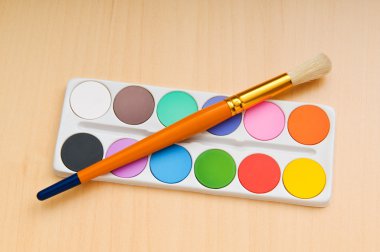 Art concept with painters palette and paint brush clipart