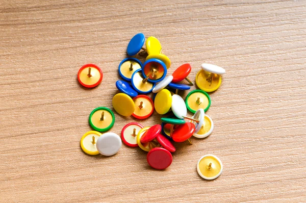 Many colourful office pins on the background — Stock Photo, Image