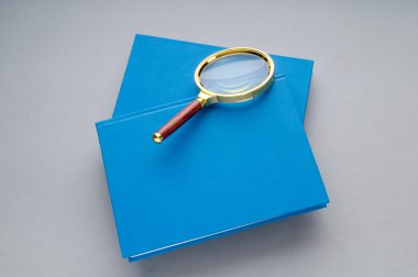 kitap yığını üzerinde büyüteç