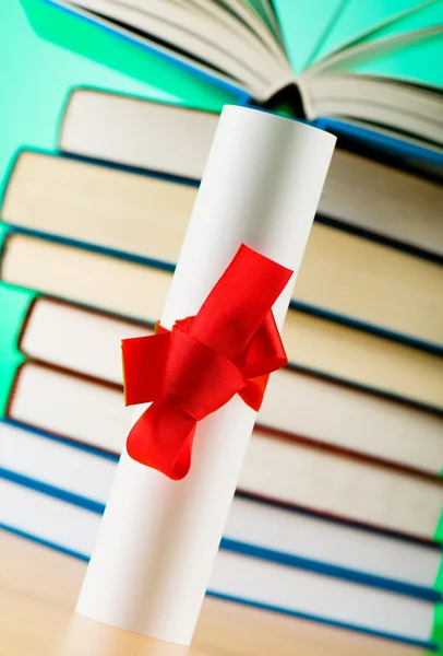 stock image Diploma and stack of books against the background