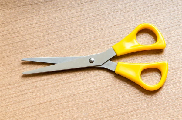 Various scissors on the wooden background — Stock Photo, Image
