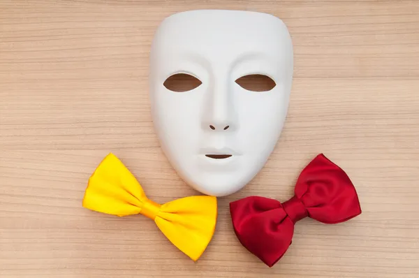 Stock image Masks and bow ties on the wooden background