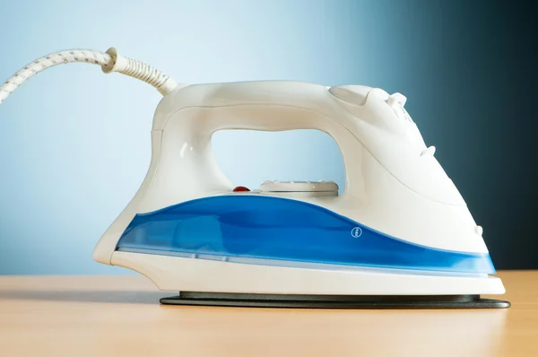 stock image Modern electric iron against the colorful background
