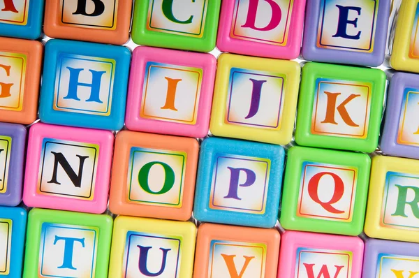 Learning and education concept - pile of alphabet blocks — Stock Photo, Image