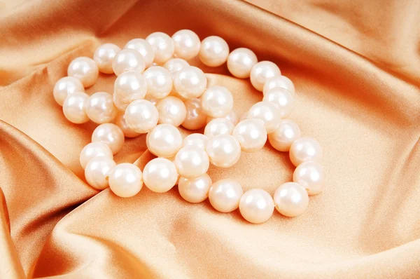 Collar de perlas en el fondo satinado brillante — Foto de Stock