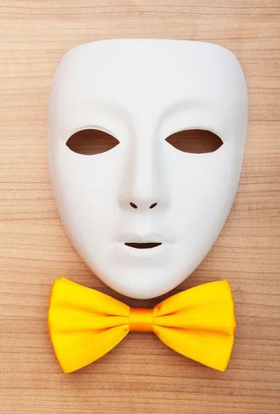Masks and bow ties on the wooden background — Stock Photo, Image