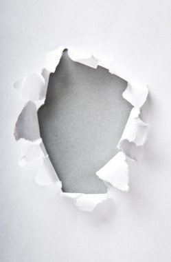 Hole in the paper with torn sides clipart