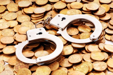 Hand cuffs and coins as security concept clipart