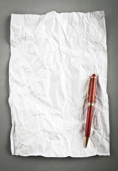 Wrinkled paper background with pen — Stock Photo, Image