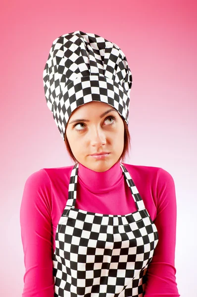 Young female cook against gradient background — Stock Photo, Image