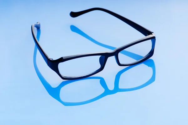 Lectura óptica gafas en el fondo —  Fotos de Stock