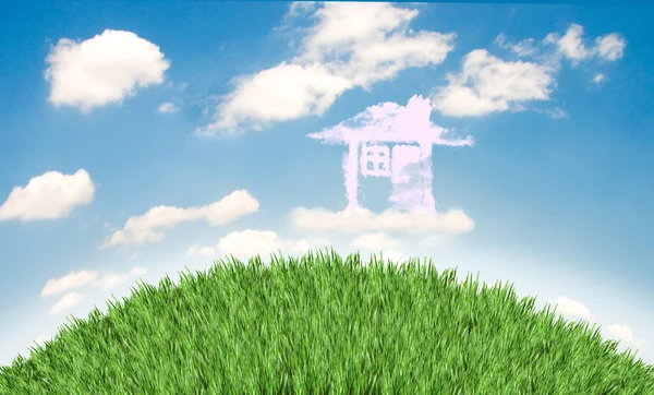 Cloud houses in the air over grass field — Stock Photo, Image