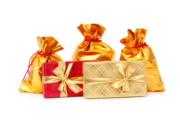 Gift boxes and golden sacks — Stock Photo, Image