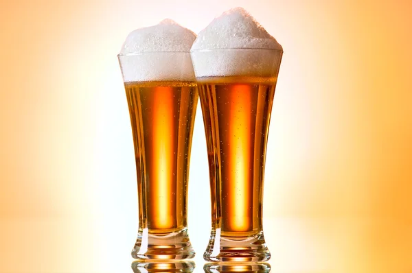 stock image Beer glasses against the colorful gradient background