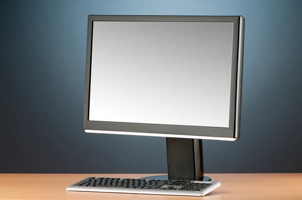 Wide screen computer monitor against colorful background — Stock Photo, Image